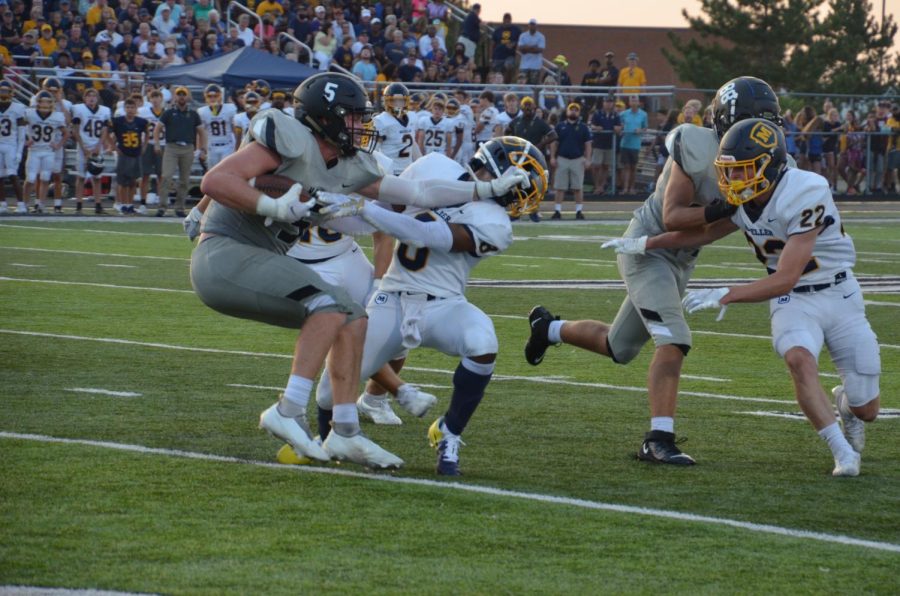East senior and Purdue commit Charlie Kenrich stiff-arms Moeller player in the first game of the season. 