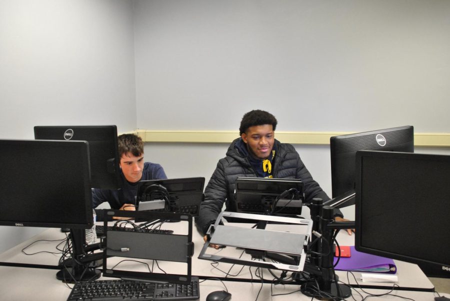 Junior Camden Frazier (left) and senior Jaiden Palmore-Lett work on an assignment in fifth bell Cyber One. 