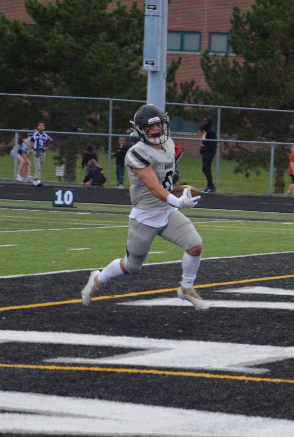 East senior Nick Rabin carries the ball into the endzone in a game in 2021. 