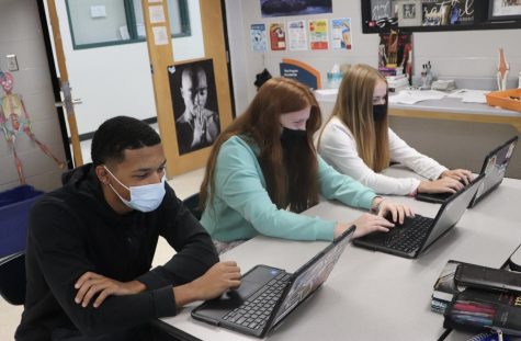 East students Kaleb Flood, Erin Cooney, and Mia Kamphuis use their school-issued chromebooks in their fitness evaluation class. 46% of Lakotas COVID-19 expenses were related to technology. 
