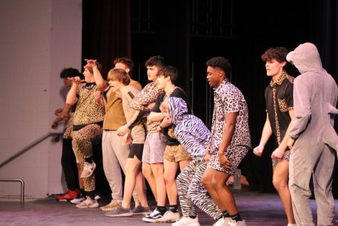 Contestants perform a group dance on stage during Mr. Lakota East. 
