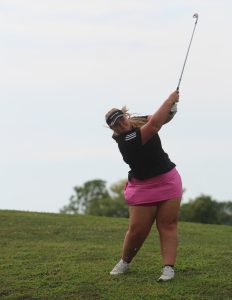 Dixon uses an iron while on a steep hill. Dixon scored a 46 overall on the course.