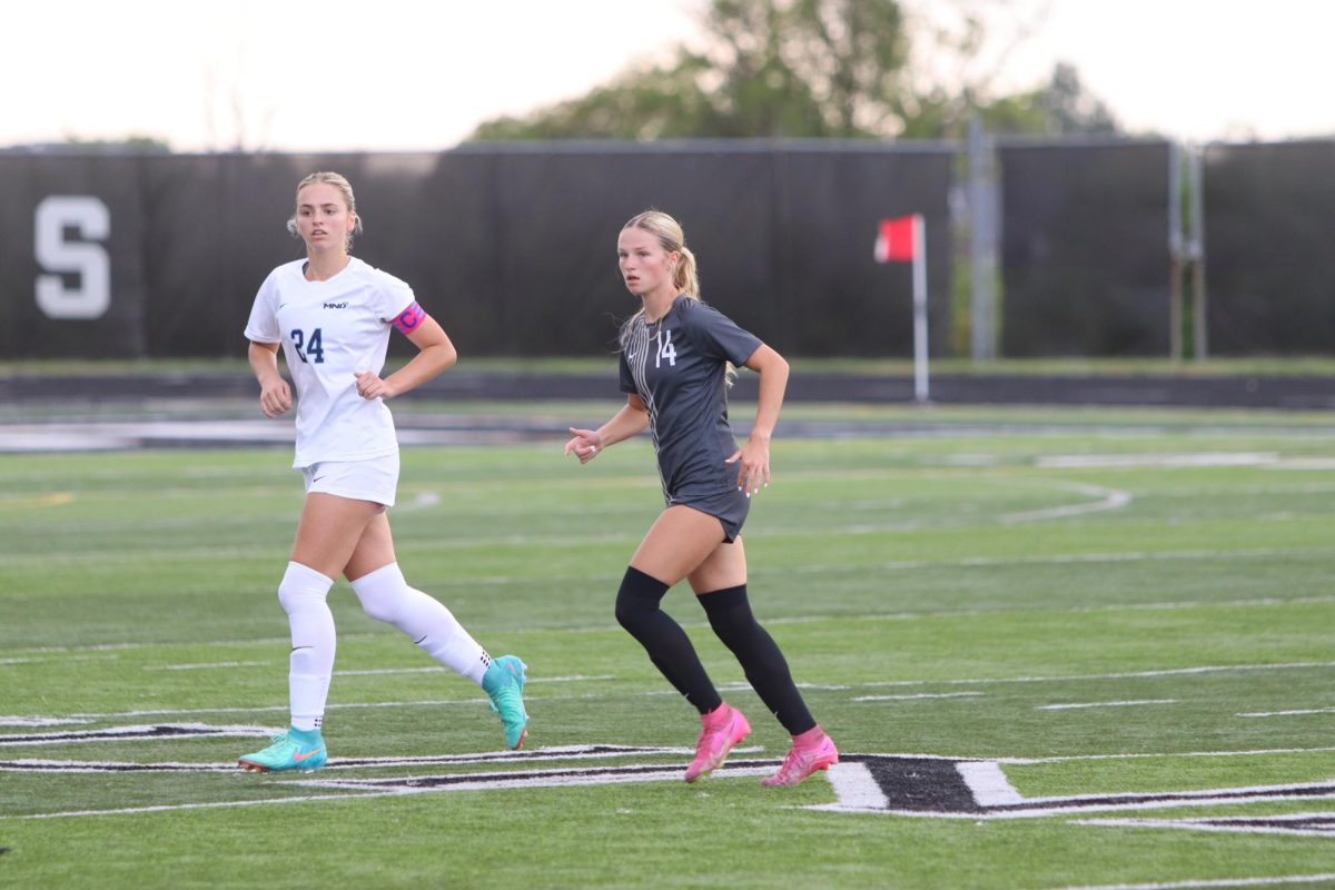 Senior Haylie Yeazell
(right) runs towards the ball
at the end of the first half.
Yeazell finishes off the first
half of the East Girls Soccer
team’s opening game against
Mount Notre Dame that
ended in a tie 0-0 game.