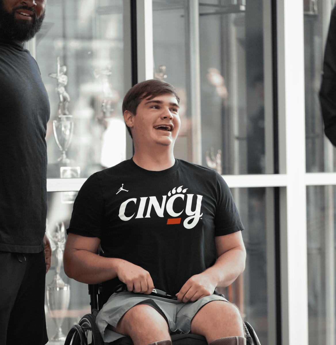 Bomar shares a laugh with coach Chenault. Bomar sits at the end of the Walk of Champions parade at Lakota East to honor his accomplishments at the 2024 track and field state meet.