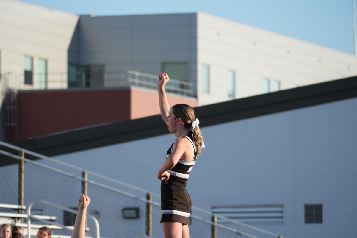 The Freshman Football Sideline Cheerleaders stunting. The girls cheer on the sidelines of the East football game against Fairfield.