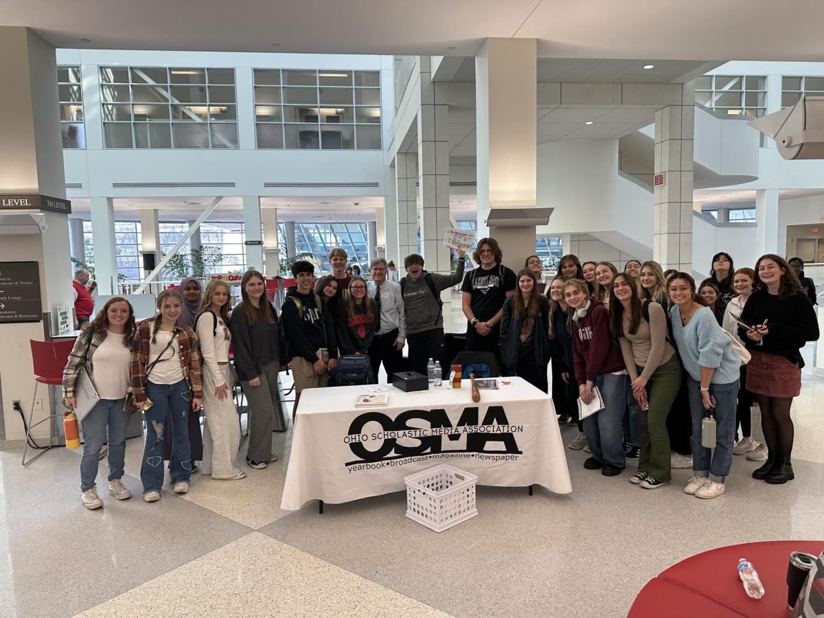 Spark staff at the Ohio Scholastic Media Association conference posed with former Journalism teacher, Dean Hume.