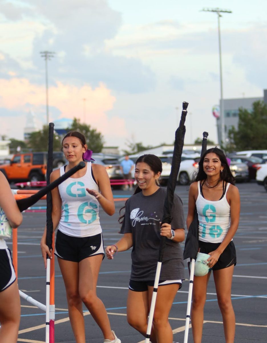 Varsity Colorguard athletes go to huddle after the parent preview show. Colorguard performed with the East Marching Band August 17, 2024 to showcase the setlist for the 2024-25 season.