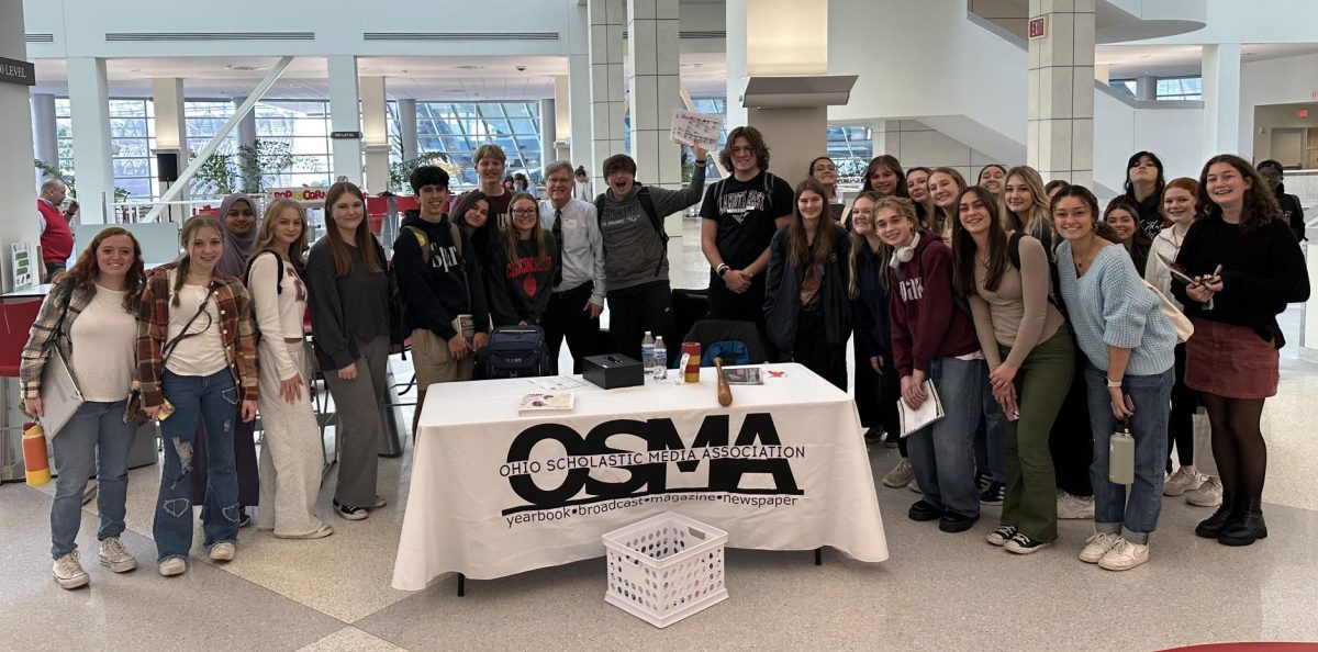 Spark staff at the Ohio Scholastic Media Association conference posed with former Journalism teacher, Dean Hume.