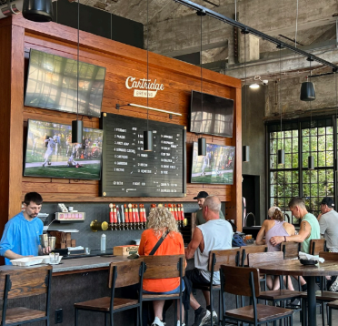 Customers gather at Cartridge Brewing's Bar. Guests are also welcome to the outdoor and indoor seating which accommodate families and large groups.